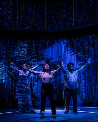 Playwright Sandra Delgado (center, pictured with cast members Charín Álvarez, visible front left; Brian King, visible back left; and Ramón Camín, visible front right) also stars as Clara in HUNDREDS AND HUNDREDS OF STARS.
