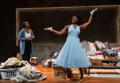 Miss Candice (Leslie Ann Sheppard, right) is an unsettling character who steps out of an algorithm and into the life of Mia (Kristin E. Ellis) in Shattered Globe Theatre’s Midwest Premiere of Morning, Noon, and Night. Obie Award-winning playwright Kirsten Greenidge’s mind-bending drama explores teens, family, surveillance, and connection in a post-pandemic world. AmBer Montgomery directs. Performances run through March 28, 2026 at Theater Wit, 1229 W. Belmont Ave., Chicago. Tickets: sgtheatre.org or (773) 975-8150.